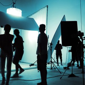 Shooting studio for photographer and creative art director with production crew team setting up ligh