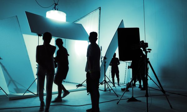 Shooting studio for photographer and creative art director with production crew team setting up ligh